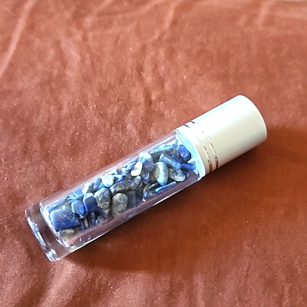 Empty glass roll on bottle with Lapis Lazuli chips inside